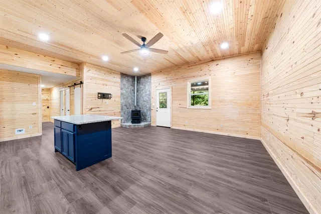 a living room with wooden floors and ceiling fan
