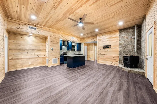 a open kitchen with a refrigerator and a stove top oven