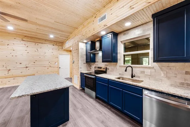 a kitchen with a sink stove and cabinets