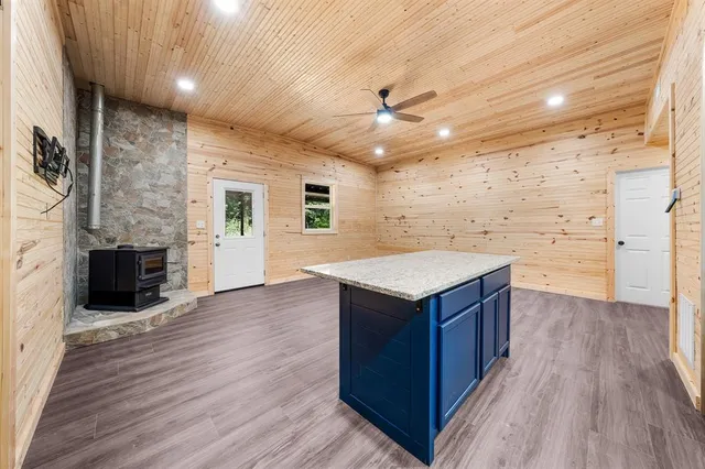 an empty room with wooden floor and fireplace