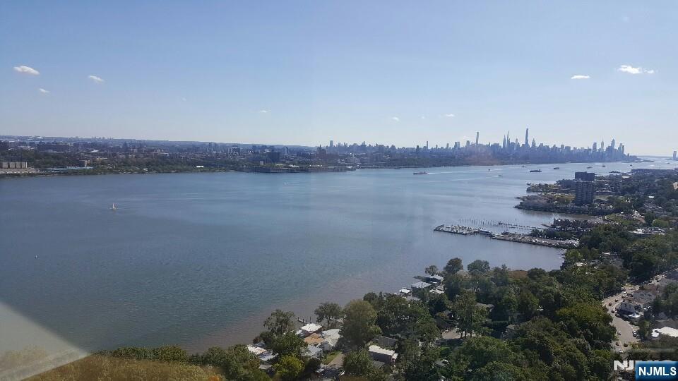 100 Old Palisade Road, Unit 1001 Fort Lee, NJ 07024 - Photo 3 of 3 a view of a lake and mountain in the back