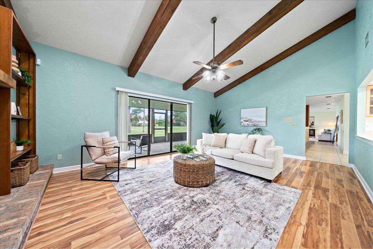 271 Sandy Run Melbourne, FL 32940 - Photo 12 of 41 a living room with furniture a chandelier and a rug