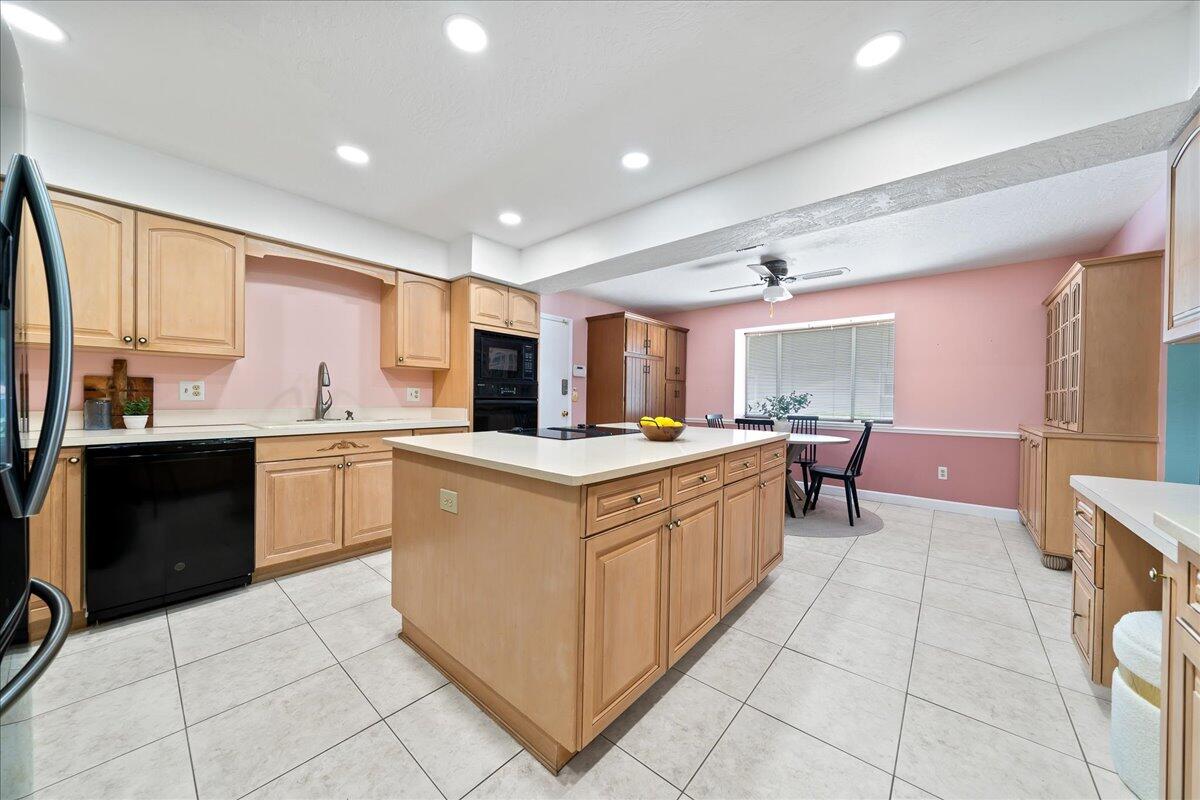 271 Sandy Run Melbourne, FL 32940 - Photo 14 of 41 a kitchen with stainless steel appliances granite countertop a large counter top a sink a stove a refrigerator and cabinets