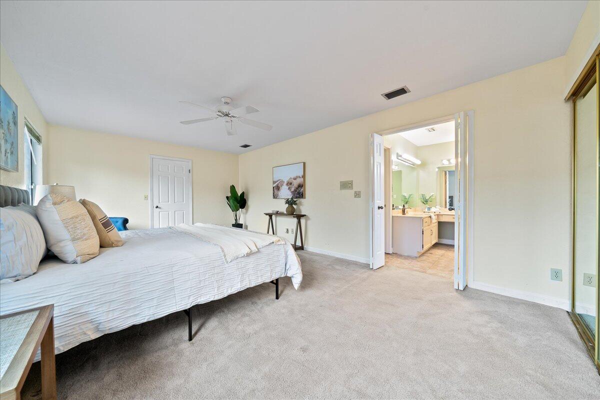 271 Sandy Run Melbourne, FL 32940 - Photo 18 of 41 a bed room with a bed and potted plant