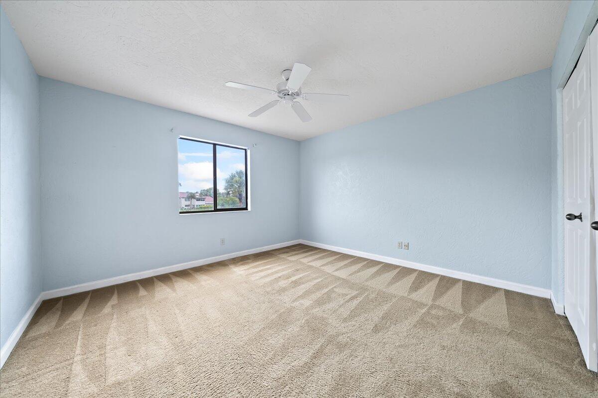 271 Sandy Run Melbourne, FL 32940 - Photo 26 of 41 an empty room with windows and ceiling fan