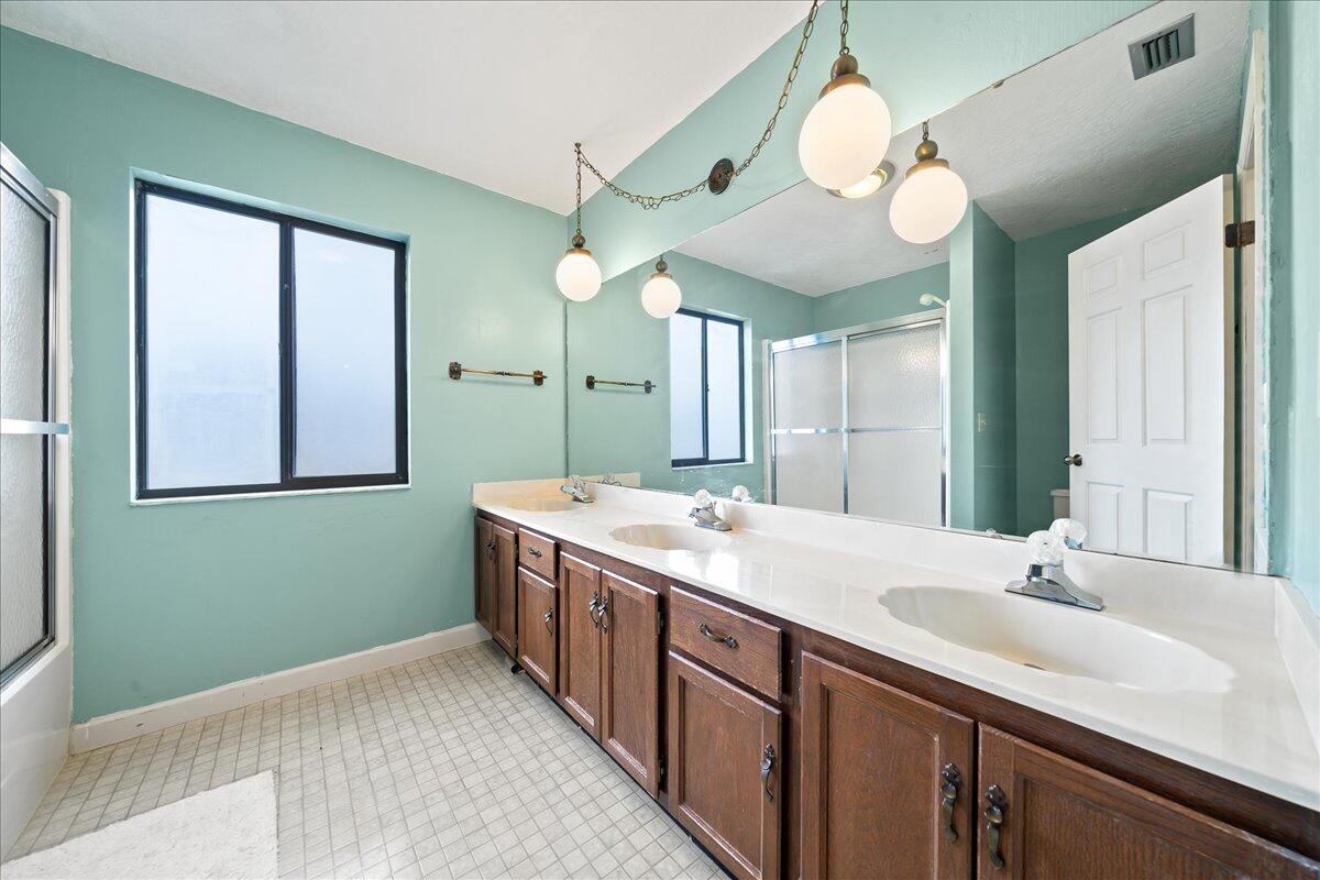 271 Sandy Run Melbourne, FL 32940 - Photo 28 of 41 a bathroom with a sink and a large mirror