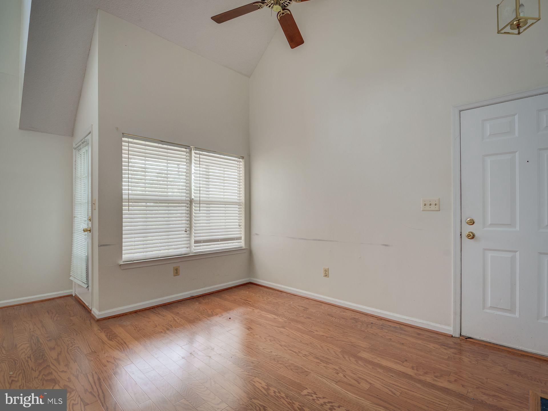 14059 Vista Drive, Unit 141 Laurel, MD 20707 - Photo 11 of 33 an empty room with wooden floor cabinet and windows