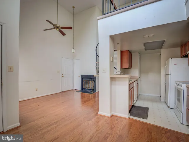 a view of a kitchen with a sink stove refrigerator and cabinets
