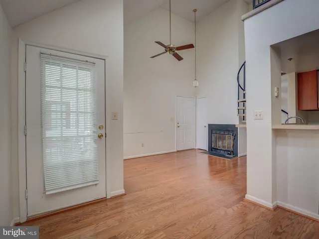 a view of a room with an empty space and a window