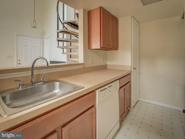 a kitchen with stainless steel appliances granite countertop a sink and a microwave