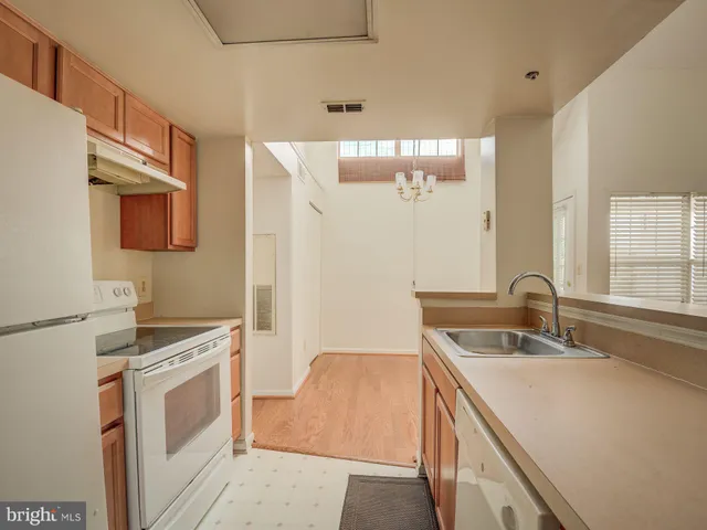a kitchen that has a sink a stove and a microwave