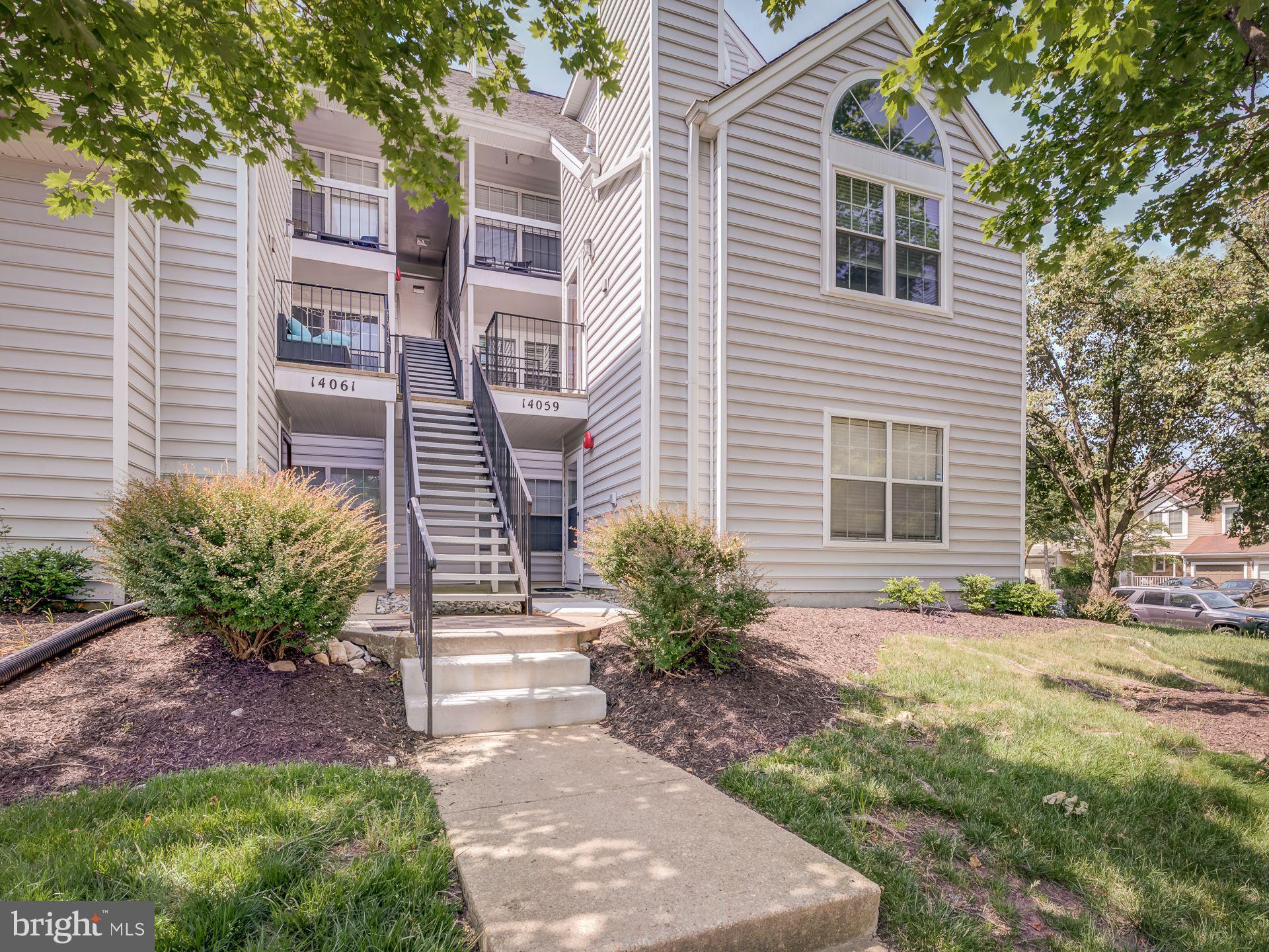 14059 Vista Drive, Unit 141 Laurel, MD 20707 - Photo 2 of 33 a front view of a house with garden