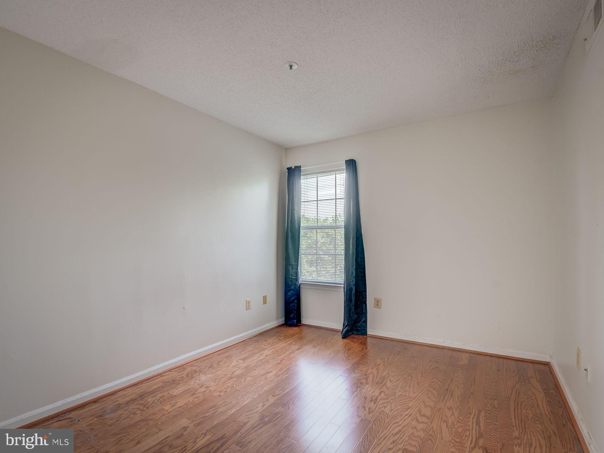 14059 Vista Drive, Unit 141 Laurel, MD 20707 - Photo 24 of 33 a view of an empty room with wooden floor and fan