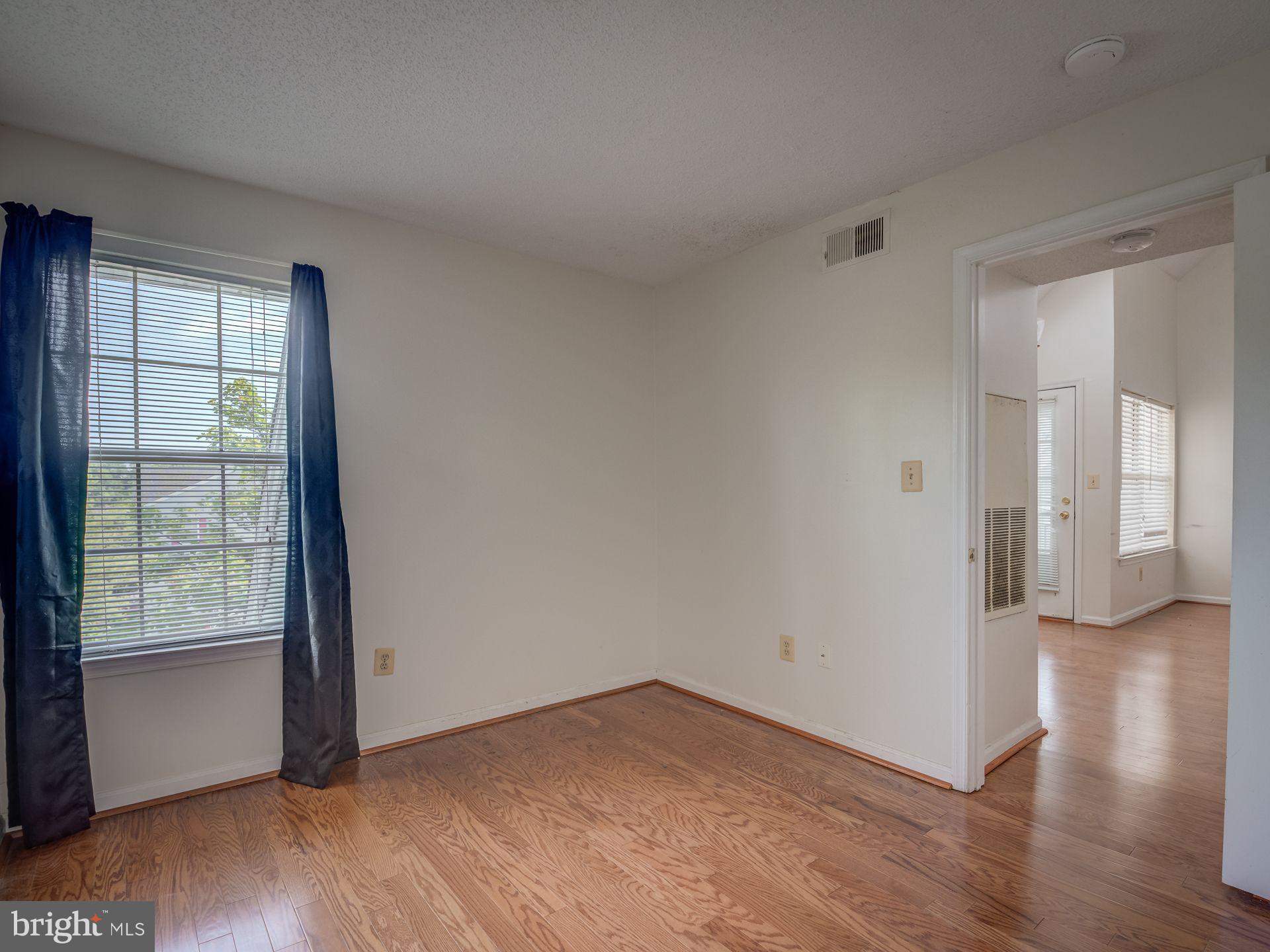 14059 Vista Drive, Unit 141 Laurel, MD 20707 - Photo 25 of 33 wooden floor in an empty room with a window
