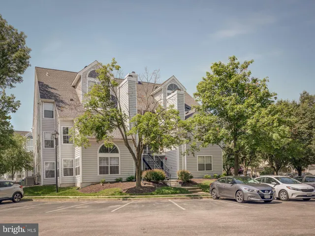a couple of cars parked in front of a house