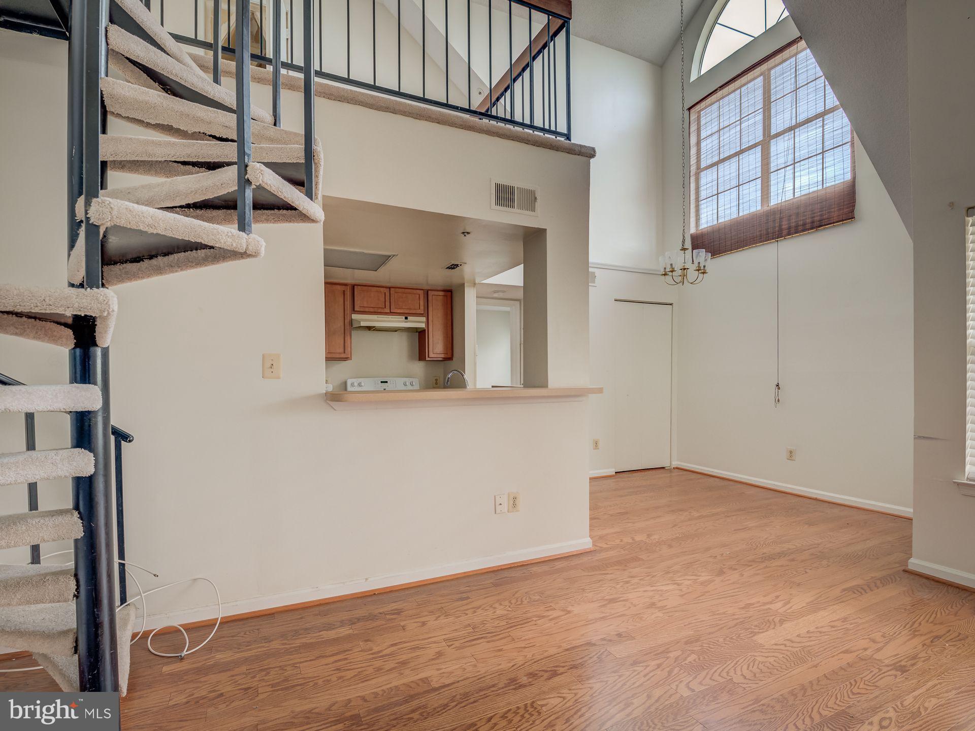 14059 Vista Drive, Unit 141 Laurel, MD 20707 - Photo 10 of 33 an empty room with wooden floor and windows