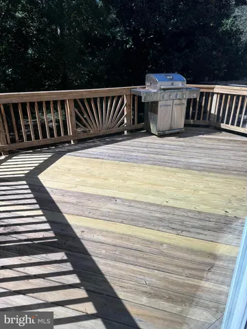 a view of a balcony with wooden floor and fence