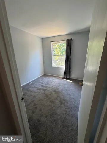 a view of hallway with window and stairs