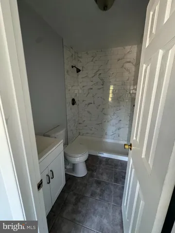 a bathroom with a toilet and shower