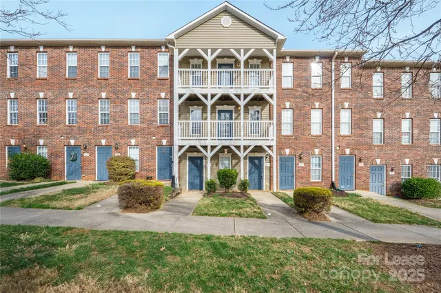 a front view of a building with a yard