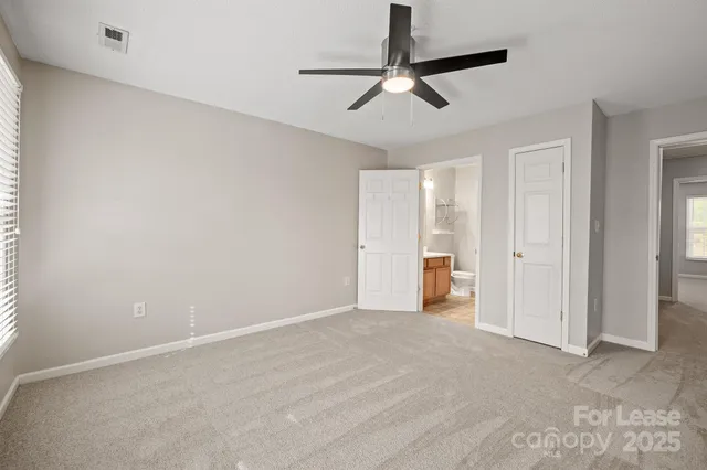 wooden floor in an empty room and a ceiling fan