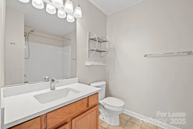 a bathroom with a sink vanity granite and toilet