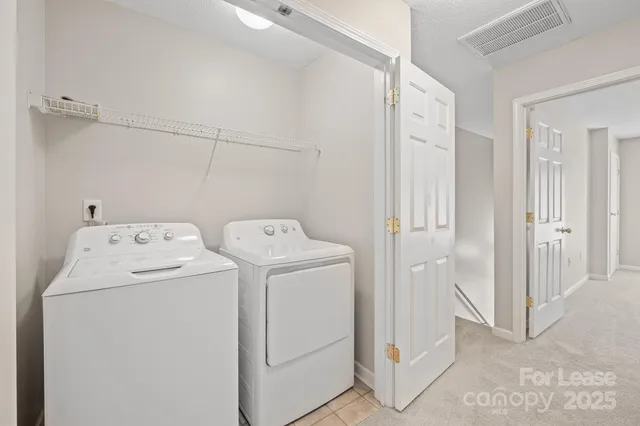 a view of storage and utility room with dryer and washer