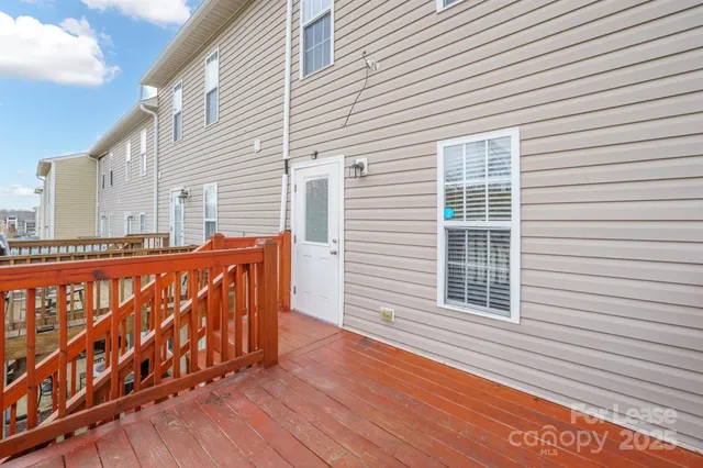 a view of a house with wooden deck