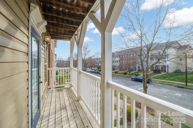 a view of a porch with wooden floor and fence