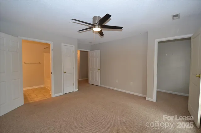 a view of empty room with ceiling fan