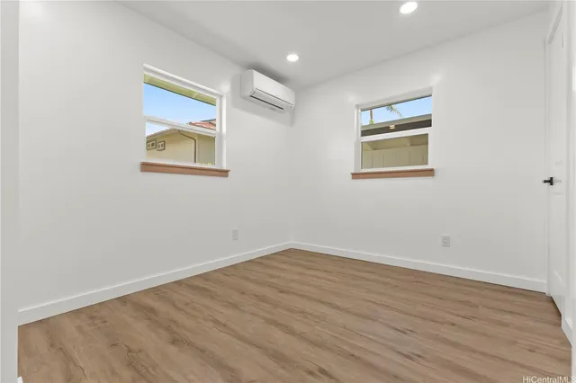 a view of a room with wooden floor and window