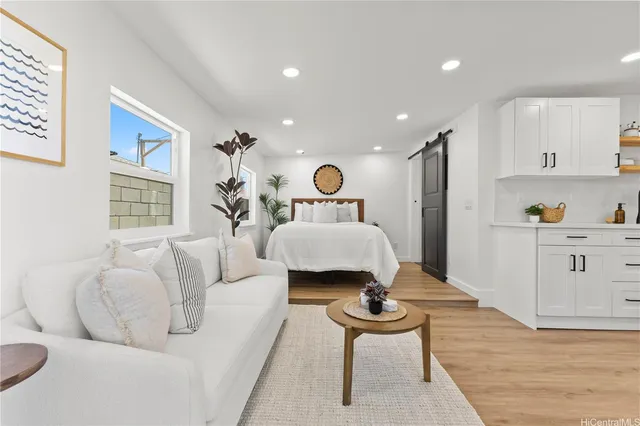 a spacious bedroom with a bed and a couch