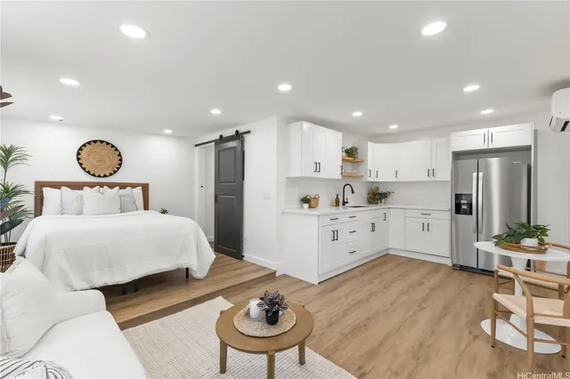 a bedroom with a bed and a chair in it