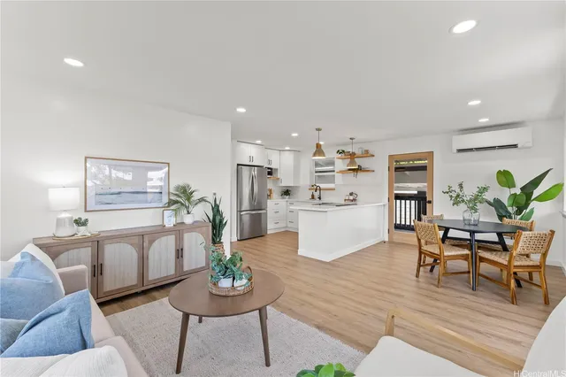 a living room with furniture and kitchen view