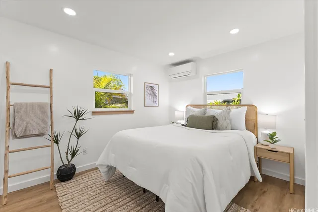 a bedroom with a bed and wooden floor