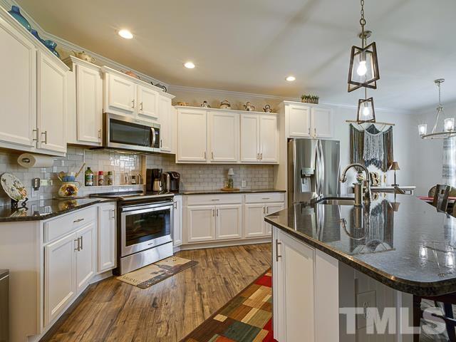 40 Fisher Road Lillington, NC 27546 - Photo 20 of 47 a kitchen with kitchen island granite countertop a sink cabinets and stainless steel appliances
