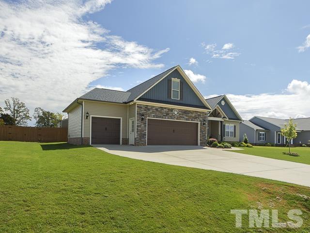 40 Fisher Road Lillington, NC 27546 - Photo 2 of 47 a front view of a house with a yard and garage