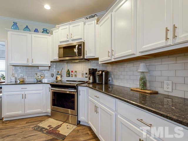 40 Fisher Road Lillington, NC 27546 - Photo 24 of 47 a kitchen with stainless steel appliances granite countertop a sink a stove and cabinets