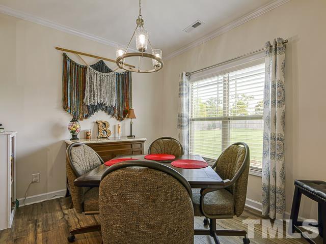40 Fisher Road Lillington, NC 27546 - Photo 27 of 47 a view of a dining room with furniture window and wooden floor