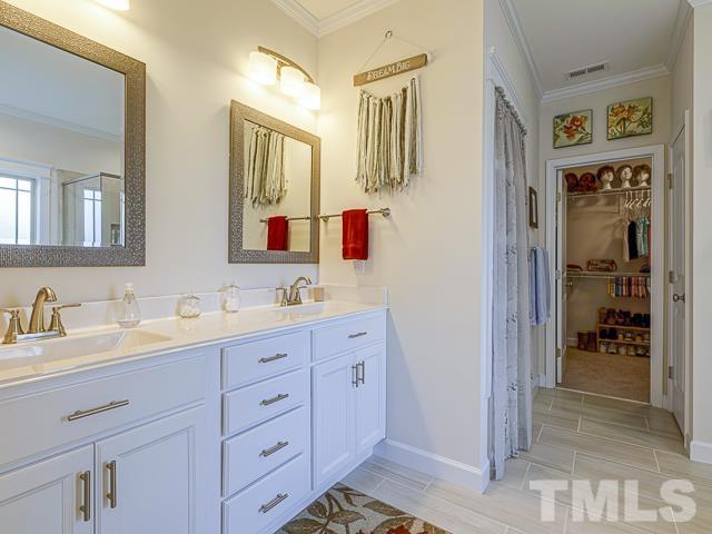 40 Fisher Road Lillington, NC 27546 - Photo 32 of 47 a bathroom with double vanity sinks a vanity and a shower