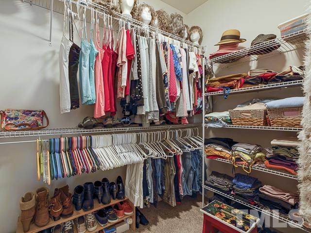 40 Fisher Road Lillington, NC 27546 - Photo 34 of 47 a view of walk in closet with clothes and shoes