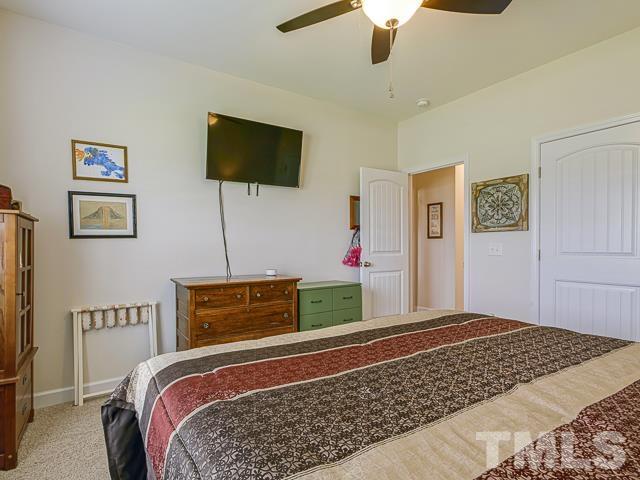 40 Fisher Road Lillington, NC 27546 - Photo 36 of 47 a bedroom with bed and flat screen tv