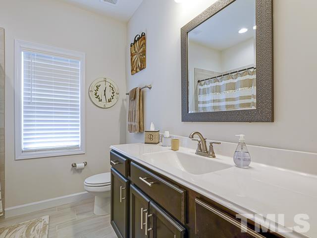 40 Fisher Road Lillington, NC 27546 - Photo 37 of 47 a bathroom with a sink a mirror and a toilet