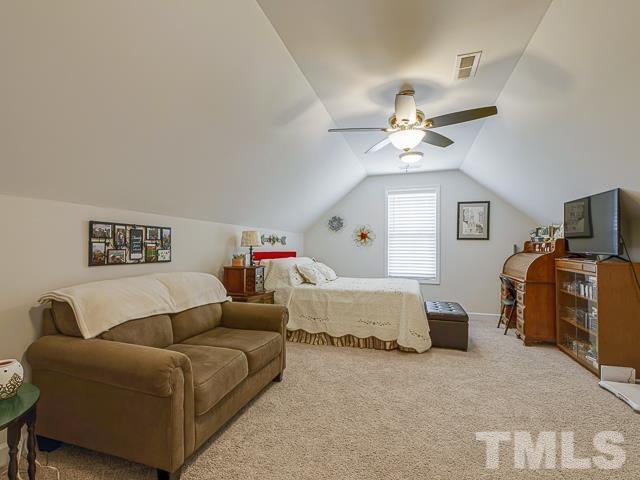 40 Fisher Road Lillington, NC 27546 - Photo 42 of 47 a living room with furniture and a chandelier