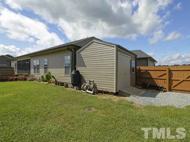 40 Fisher Road Lillington, NC 27546 - Photo 45 of 47 a backyard of a house with table and chairs