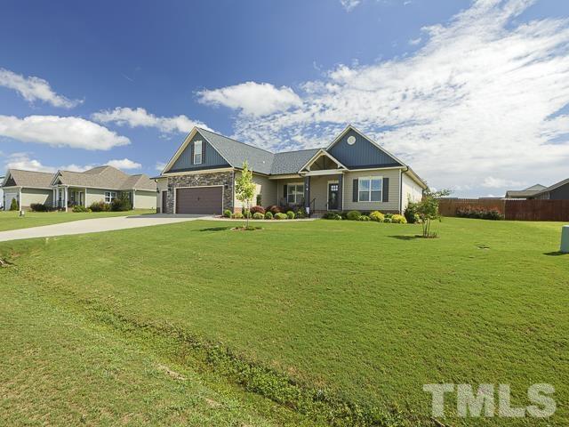 40 Fisher Road Lillington, NC 27546 - Photo 5 of 47 a view of a house with a big yard and large trees