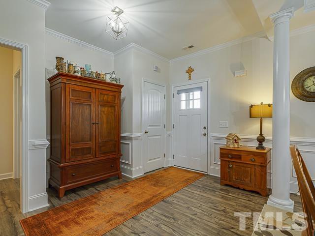 40 Fisher Road Lillington, NC 27546 - Photo 8 of 47 a bedroom with a bed and a chandelier