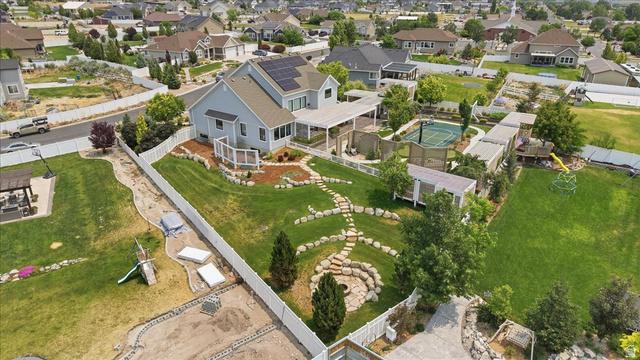 2038 East Ranch Road Eagle Mountain, UT 84005 - Photo 65 of 66 Expansive backyard featuring a stone pathway, a dedicated sports court, a pergola-covered patio, and a fire pit area