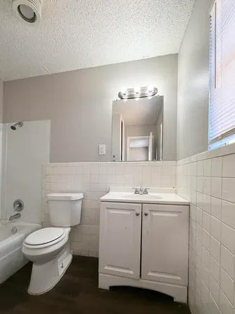a bathroom with a toilet sink and mirror