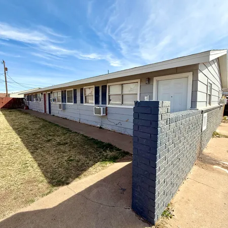 a view of a house with wooden fence
